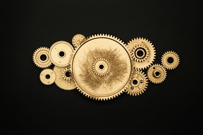 Golden gears against a black background