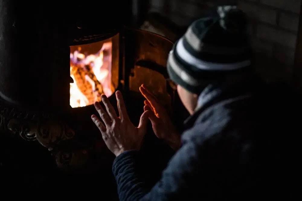 A person warming their hands by a fire