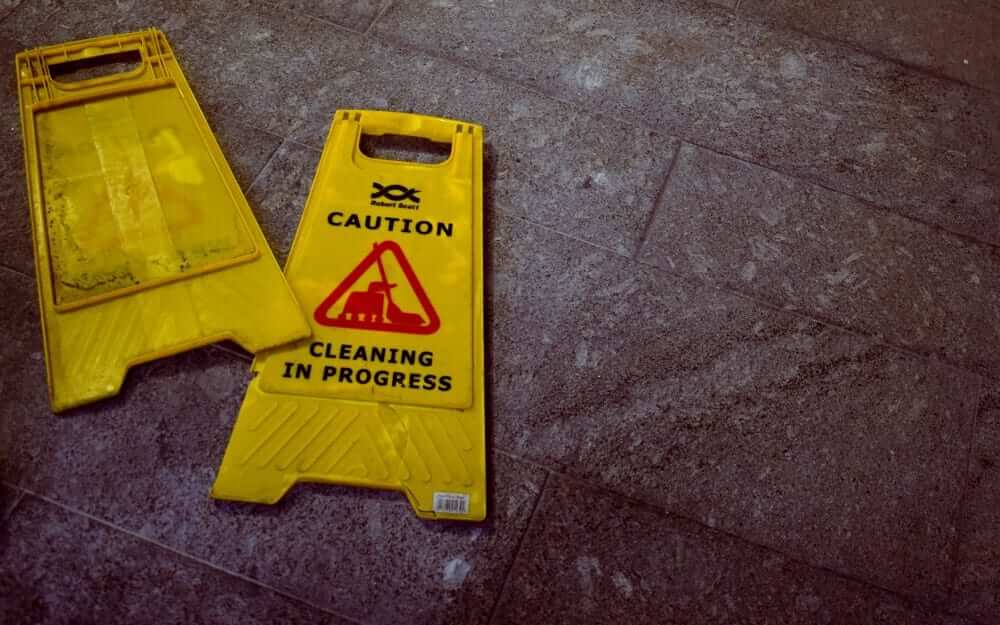 Two warning plaques that read 'cleaning in progress'