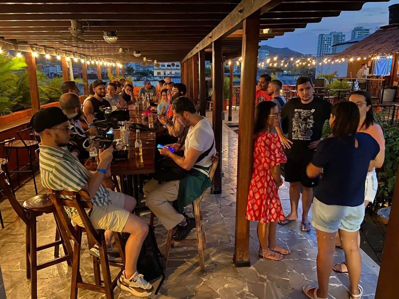 A group of people on a long table on a rooftop