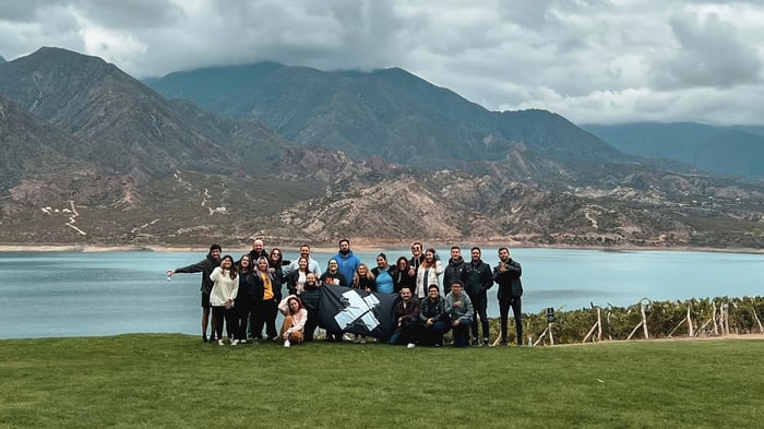 A group of X-Teamers posing for a photo in front of a mountain range