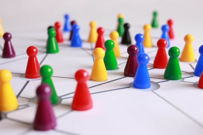 A group of colorful pawns on a white table