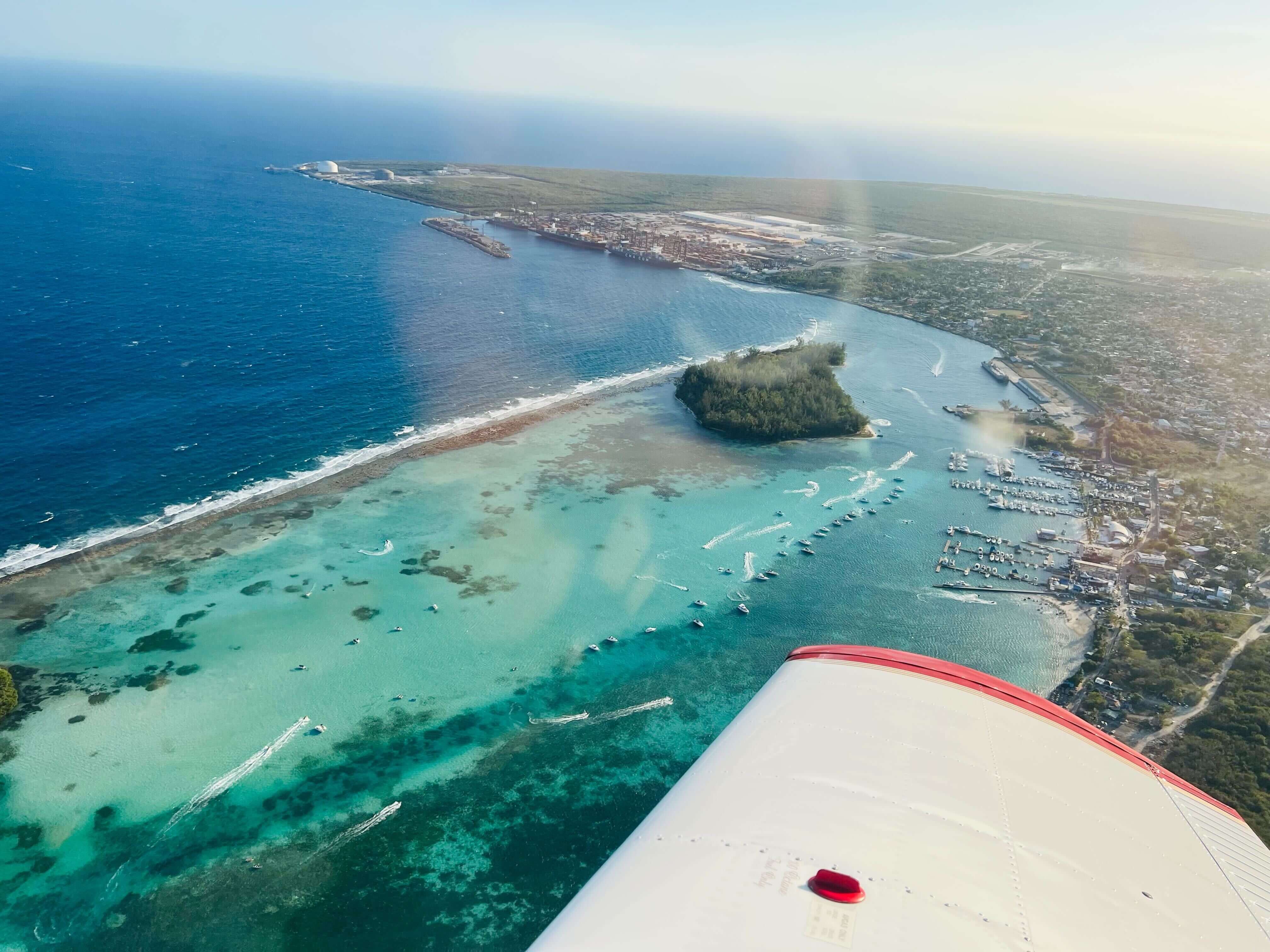 A beautiful view of a coastline, taken from the cockpit of a small plane
