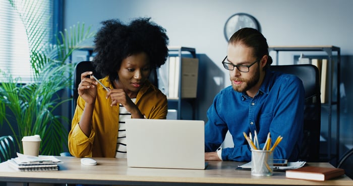 two people meeting in front of a laptop