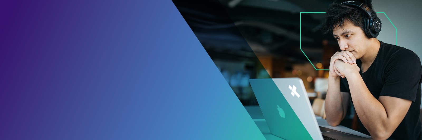 X-Team engineer in a teal top writing at a desk