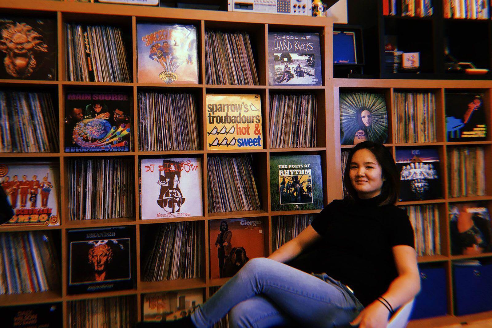 Employee sitting in front of bookshelf